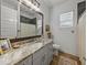 Stylish bathroom featuring granite countertop, framed mirror, and tiled shower at 128 Melissa Trl, Auburndale, FL 33823