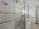 Bright bathroom showcasing a walk-in glass shower, neutral tones, and wood-look tile floors at 128 Melissa Trl, Auburndale, FL 33823