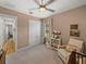 Neutral Bedroom with crib, rocker, and natural light from window at 128 Melissa Trl, Auburndale, FL 33823