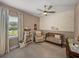 Cozy Bedroom with floral wallpaper, crib, rocker, and window at 128 Melissa Trl, Auburndale, FL 33823