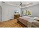 Bright bedroom features wood floors, neutral paint, updated trim, and natural light from the exterior at 128 Melissa Trl, Auburndale, FL 33823