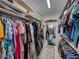 Walk-in closet offering ample storage space with shelving and racks for an organized wardrobe at 128 Melissa Trl, Auburndale, FL 33823