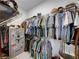 Walk-in closet features ample storage space, metal rack shelving, and space for storage at 128 Melissa Trl, Auburndale, FL 33823