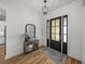 Welcoming entryway featuring wood floors, stylish lighting, and decor at 128 Melissa Trl, Auburndale, FL 33823
