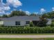 Home exterior showcases a screened-in patio and landscaped backyard at 128 Melissa Trl, Auburndale, FL 33823