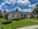 Well-maintained home with lush landscaping, colorful flowers and a manicured lawn at 128 Melissa Trl, Auburndale, FL 33823