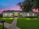 Charming home featuring a brick walkway, well-manicured lawn, and beautiful landscaping at 128 Melissa Trl, Auburndale, FL 33823