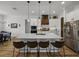 Well-appointed kitchen with white cabinetry, a center island with seating, and modern pendant lights at 128 Melissa Trl, Auburndale, FL 33823