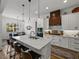 Stylish kitchen featuring a marble island, wooden accents, and an adjacent dining area at 128 Melissa Trl, Auburndale, FL 33823