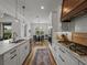 Bright, modern kitchen featuring an island with seating and views of the living and dining areas at 128 Melissa Trl, Auburndale, FL 33823