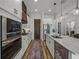 Modern kitchen with stainless appliances, granite counters, a center island, and open access to other living areas at 128 Melissa Trl, Auburndale, FL 33823