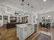 Open-concept kitchen with island seating, stainless appliances, and views into the living and dining spaces at 128 Melissa Trl, Auburndale, FL 33823