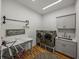 Modern laundry room features stainless steel washer and dryer, a sink, and ample counter space at 128 Melissa Trl, Auburndale, FL 33823