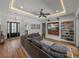 Comfortable living room with coffered ceiling and modern built-in shelving unit at 128 Melissa Trl, Auburndale, FL 33823