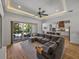 Open concept living room flows into the kitchen and outdoor patio at 128 Melissa Trl, Auburndale, FL 33823