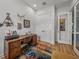 Well-lit office with wood desk, colorful rug, closet and artwork at 128 Melissa Trl, Auburndale, FL 33823