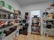 Well-organized pantry features wire shelving, wood floors, a wine cooler, and convenient storage solutions at 128 Melissa Trl, Auburndale, FL 33823