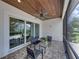 Inviting screened-in patio with ceiling fan, brick flooring, wood ceiling, and sliding glass doors at 128 Melissa Trl, Auburndale, FL 33823