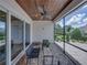 Inviting screened-in patio with ceiling fan, brick flooring, wood ceiling, and sliding glass doors at 128 Melissa Trl, Auburndale, FL 33823