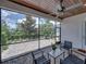 Relaxing screened-in patio with brick floors, wood ceiling, ceiling fan, and outdoor seating at 128 Melissa Trl, Auburndale, FL 33823