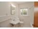 A well-lit bathroom with all-white fixtures and vintage wall tiles at 132 Kinstle Ave, Auburndale, FL 33823