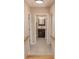 Hallway view into a bathroom with a rustic vanity and tile flooring at 132 Kinstle Ave, Auburndale, FL 33823
