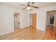 Bedroom featuring hardwood floors, neutral walls, closet space and access to hallway and bathroom at 132 Kinstle Ave, Auburndale, FL 33823