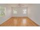 An empty bedroom featuring hardwood floors and a ceiling fan at 132 Kinstle Ave, Auburndale, FL 33823