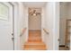 Entryway with wood stairs and floors leading into a bright room with a ceiling fan at 132 Kinstle Ave, Auburndale, FL 33823