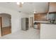 Spacious kitchen featuring tile floors, stainless appliances and access to the adjacent dining area at 132 Kinstle Ave, Auburndale, FL 33823