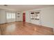 Bright living room featuring beautiful hardwood floors, neutral walls, and a traditional front door at 132 Kinstle Ave, Auburndale, FL 33823