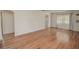 Spacious living room with hardwood floors and neutral walls, featuring an arched doorway at 132 Kinstle Ave, Auburndale, FL 33823
