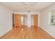 A large, bright main bedroom with wood floors, white walls, and closet space at 132 Kinstle Ave, Auburndale, FL 33823