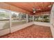 Inviting sunroom featuring a wood ceiling, tile flooring, and ample natural light from large windows at 132 Kinstle Ave, Auburndale, FL 33823