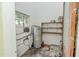 Utility room featuring water heater, shelving and a window for light at 132 Kinstle Ave, Auburndale, FL 33823