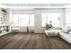 Bright living room featuring new wood-look flooring, large windows, and comfortable seating at 1468 Fleur Dr, Davenport, FL 33837