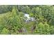 A sprawling home surrounded by vibrant trees and verdant lawns provides a serene, private retreat at 15345 Angus Rd, Polk City, FL 33868