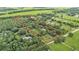 Beautiful aerial view of the expansive property with mature trees and serene surroundings at 15345 Angus Rd, Polk City, FL 33868