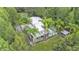 Stunning aerial view showcasing the home's setting with lush landscaping and mature trees at 15345 Angus Rd, Polk City, FL 33868