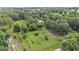 Expansive property featuring a home nestled among lush greenery and mature trees, showcasing a serene setting at 15345 Angus Rd, Polk City, FL 33868