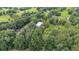 Picturesque landscape of a home, surrounded by dense trees and open fields, offering a sense of seclusion at 15345 Angus Rd, Polk City, FL 33868