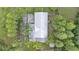 Unique aerial view of the rooftop and property features a home amidst palm trees and lush landscaping at 15345 Angus Rd, Polk City, FL 33868