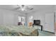 Bedroom with carpet, ceiling fan, and a sliding glass door to the sunroom at 15345 Angus Rd, Polk City, FL 33868