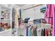 Walk-in closet featuring shelving with hanging and folded clothes and other accessories at 15345 Angus Rd, Polk City, FL 33868