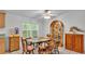 Cozy dining area adjacent to kitchen featuring decorative cabinet, natural light and ceiling fan at 15345 Angus Rd, Polk City, FL 33868