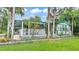 Charming exterior view of property with well-maintained lawn, mature trees, and delightful curb appeal at 15345 Angus Rd, Polk City, FL 33868