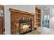 Cozy brick fireplace with wood mantel and view into adjacent living area with built-in shelving at 15345 Angus Rd, Polk City, FL 33868