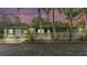 Charming single-story home with a welcoming front porch surrounded by lush landscaping and palm trees at 15345 Angus Rd, Polk City, FL 33868
