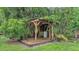 Rustic wooden gazebo surrounded by lush greenery with a weathered wood floor at 15345 Angus Rd, Polk City, FL 33868