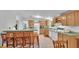Functional kitchen with breakfast bar, white appliances, and ample counter space at 15345 Angus Rd, Polk City, FL 33868